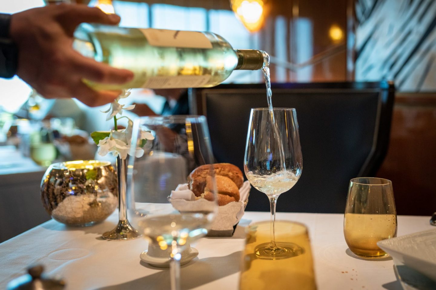 Image of person pouring wine during stewardess training