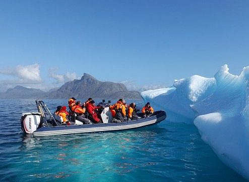 Powerboat: Rib with deckhand driving near iceberg