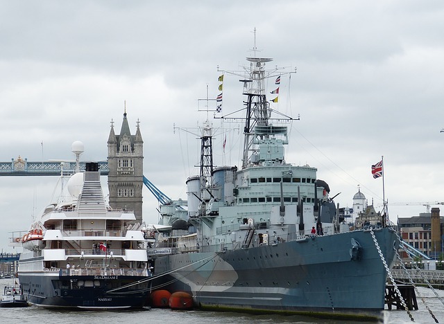 superyacht and warship on the Thames river, England, UK