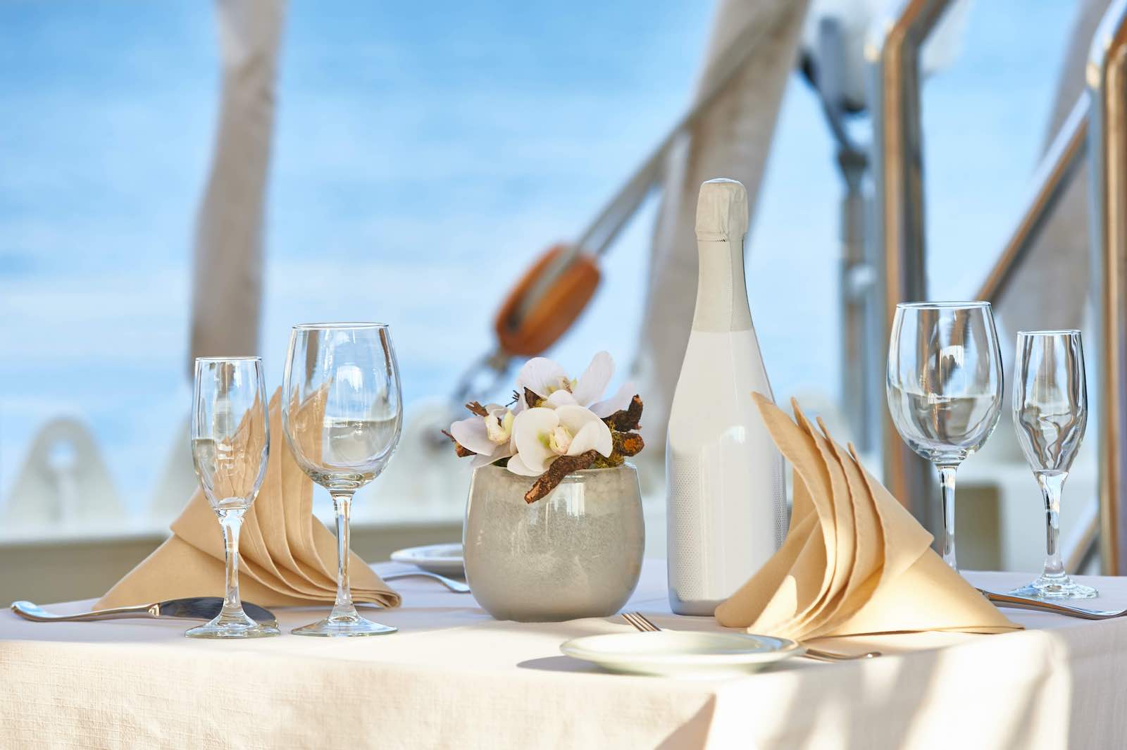 Romance on a sailing yacht. Beautiful table setting in a marine style. Yachting. Cruises