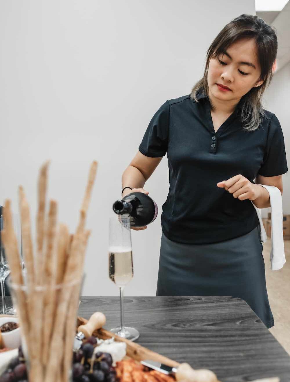 Yacht Stewardess Pouring Wine