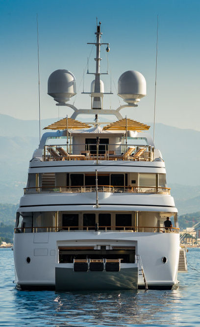 Big,White,Super,Yacht,,View,From,The,Stern,,Anchored,In