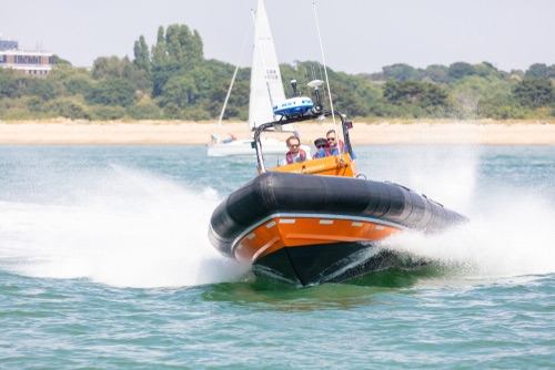 Southampton Water, Hampshire, UK; 7th July 2018; Hamble Lifeboat RHIB at speed With Three Men on board