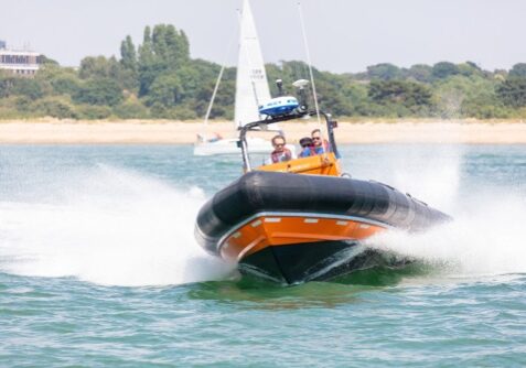 Southampton Water, Hampshire, UK; 7th July 2018; Hamble Lifeboat RHIB at speed With Three Men on board