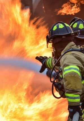 Image of two crew members fighting a fire during STCW superyacht training.