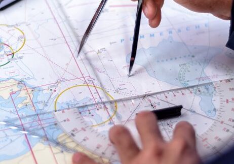 navigation with sea charts in the chart room on a sailing yacht