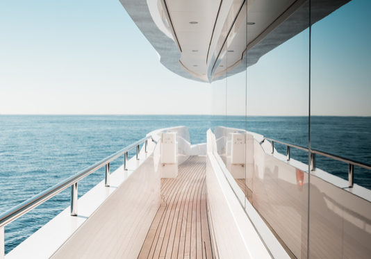 Beautiful detail of a superyacht upper deck corridor reflection on the glass windows, featuring the yacht's architectural design