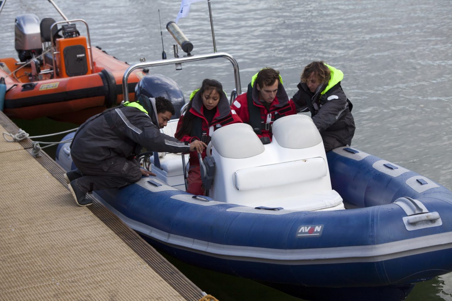 Crew sitting in a small powerboat during their level 2 training to work on yachts